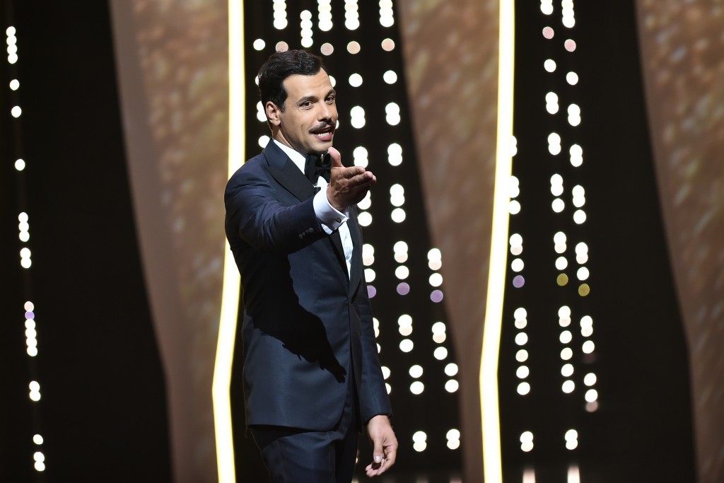 French actor and Master of Ceremony Laurent Lafitte talks on stage on May 11, 2016 during the opening ceremony for the 69th Cannes Film Festival, southern France. / AFP PHOTO / ALBERTO PIZZOLI