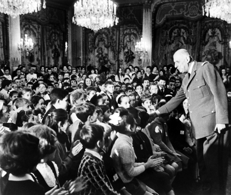French President of provisional government Charles de Gaulle waves children during a Christmas party for the staff children at the Elysee Palace in Paris on December 13, 1968. / AFP PHOTO / POOL / -